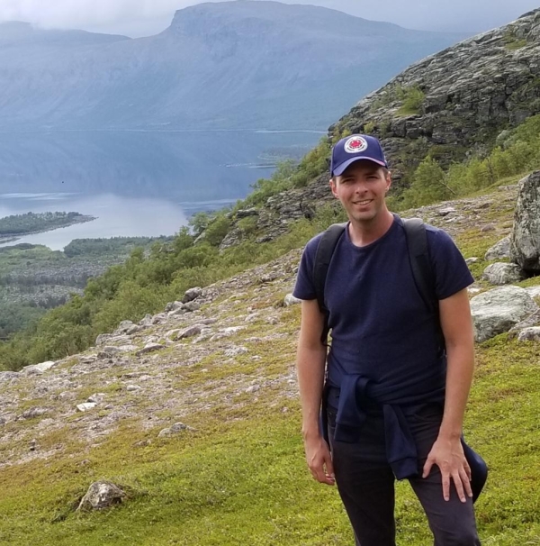 Mathieu Leblond standing outside with valley and mountains in the background