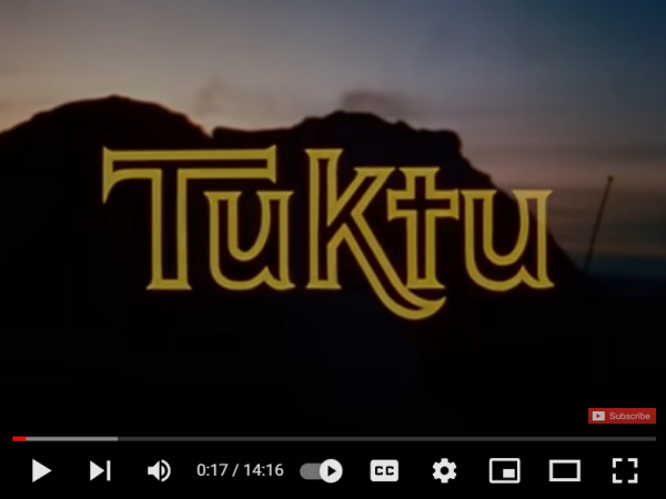 The word Tuktu spelt out in outkline in front of a mountain landscape