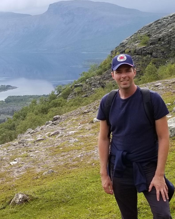 Mathieu Leblond standing outside with valley and mountains in the background