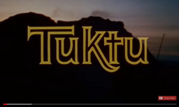 The word Tuktu spelt out in outkline in front of a mountain landscape