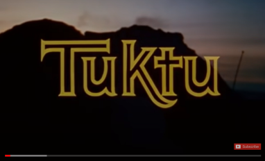 The word Tuktu spelt out in outkline in front of a mountain landscape